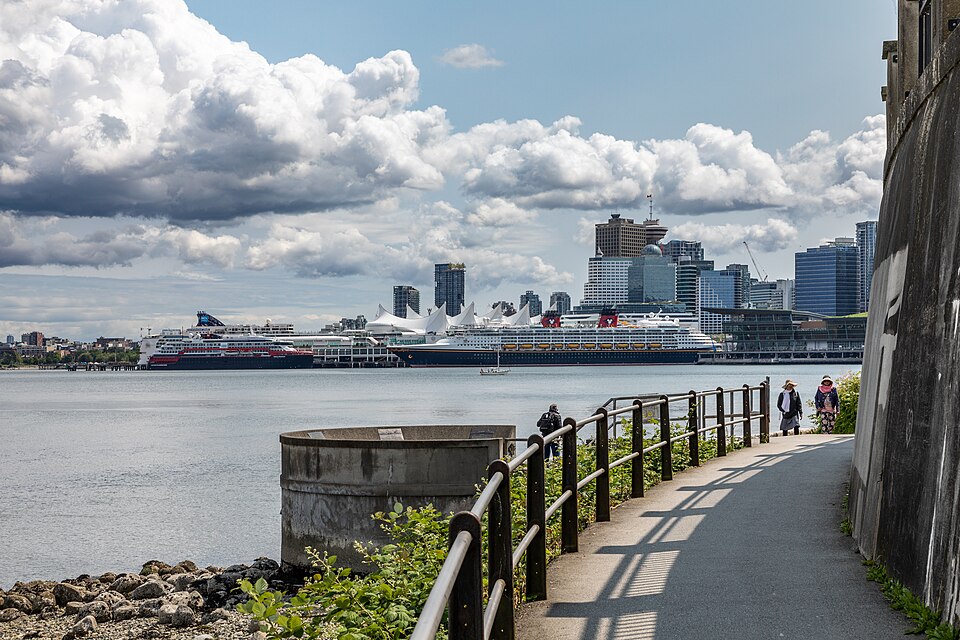 The Stanley Park seawall path with cruise ships and downtown Vancouver behind