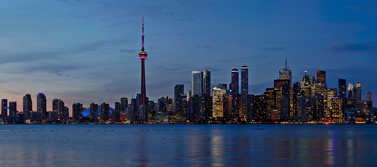 The Toronto skyline and CN Tower at dusk across the water