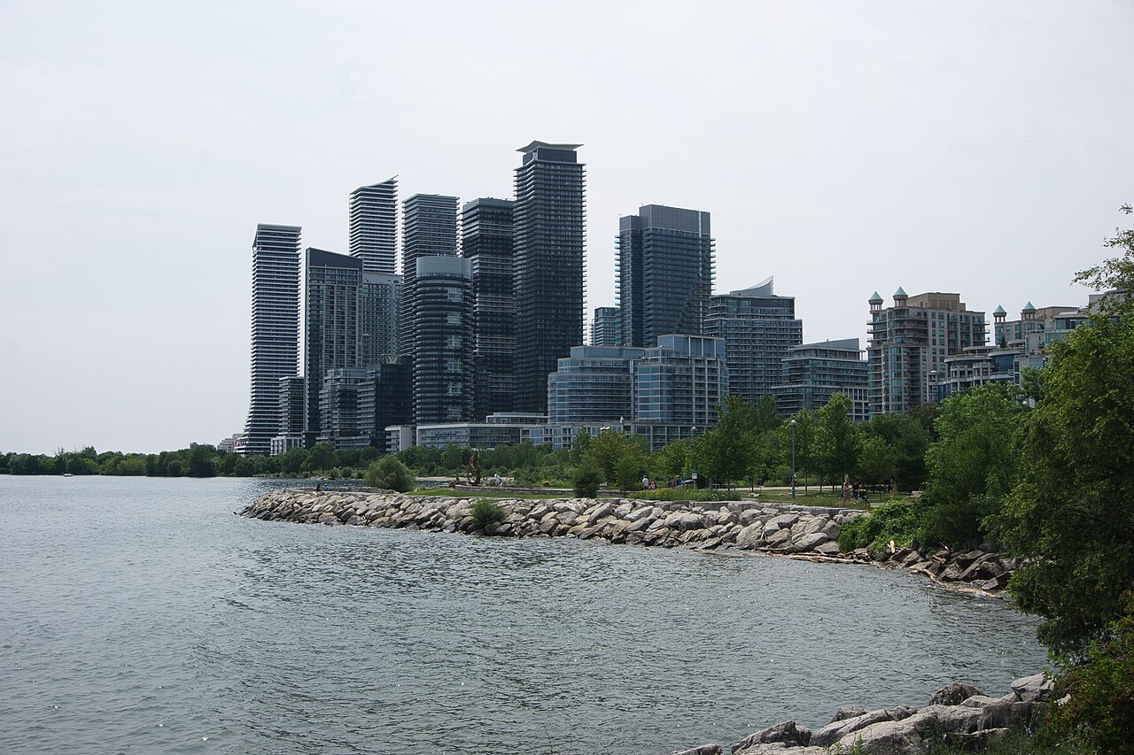 Condominium towers behind a rocky Lake Ontario shoreline at Humber Bay in Toronto
